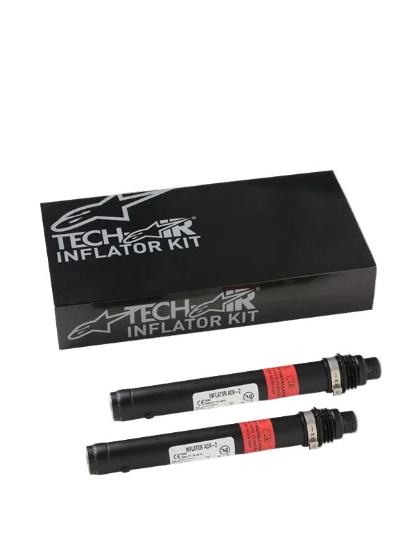 Alpinestars Tech-Air 3 V2 Airbag System Replacement Canisters, two black cylindrical argon gas inflators with red warning labels, black Tech-Air Inflator Kit box with silver Alpinestars branding, essential maintenance kit for motorcycle airbag systems