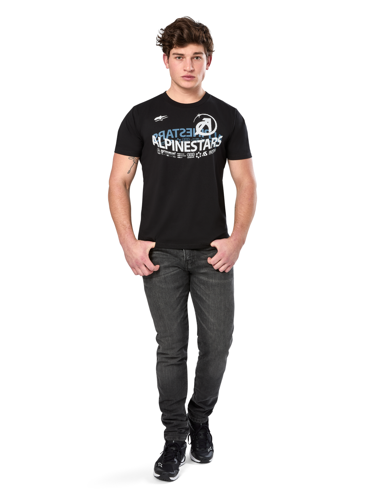 Alpinestars Semicircle CSF Tee, Short Sleeve T-Shirt, Black, White and light blue curved graphic on chest, worn by model with dark grey jeans and black sneakers, casual motorsport streetwear