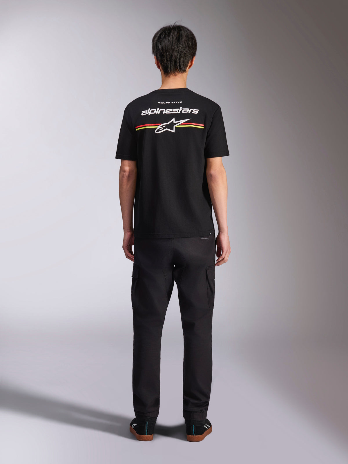 Alpinestars Lanes CSF Tee, Short Sleeve T-Shirt, Black, Back View with White Alpinestars Logo and Red and Yellow Stripes, Casual Motorsport Streetwear