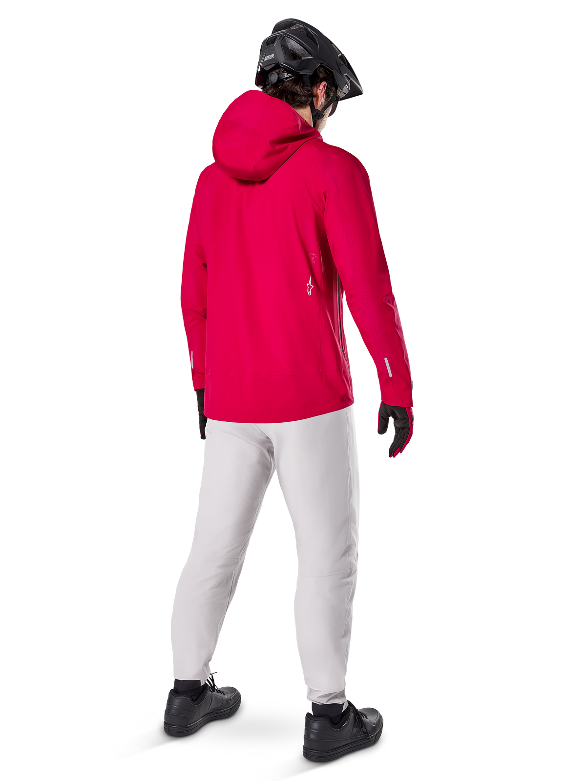 Alpinestars A-Dura Elite Waterproof Jacket, Red Fluo, three-quarter back view, worn with light gray pants and black MTB helmet, features a hood and reflective accents, high-performance cycling rain jacket for trail riding