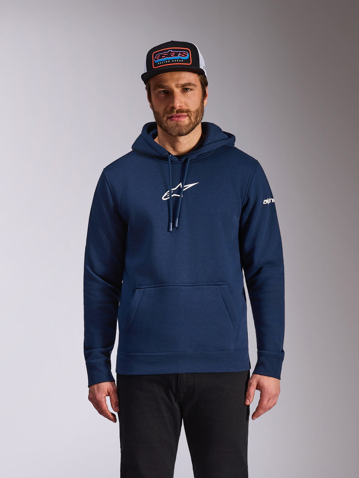Alpinestars Frontal Hoodie, casual motorsport streetwear, Navy blue with white Astars logo on chest and white word logo on sleeve, kangaroo pocket, drawstring hood, worn by model