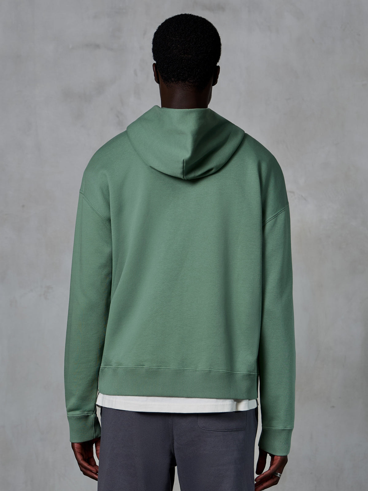 Alpinestars Essentials Ageless Zip Hoodie, back view on model, Cactus green, casual motorsport-inspired streetwear, relaxed fit with ribbed hem and cuffs, high-quality compact fleece