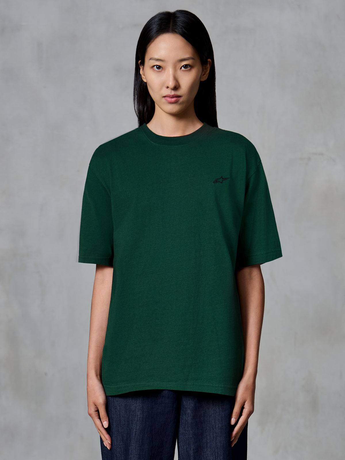 Alpinestars Essentials Ageless SS Tee, Short Sleeve T-Shirt, Pine Green, worn by model, featuring a small black chest logo, relaxed fit, organic cotton casual streetwear
