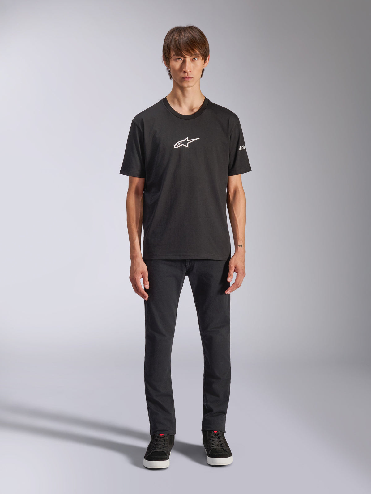 Alpinestars Frontal CSF Tee, Short Sleeve T-Shirt, Black, White Alpinestars logo on chest, worn by model with black pants and black shoes, casual performance sportswear