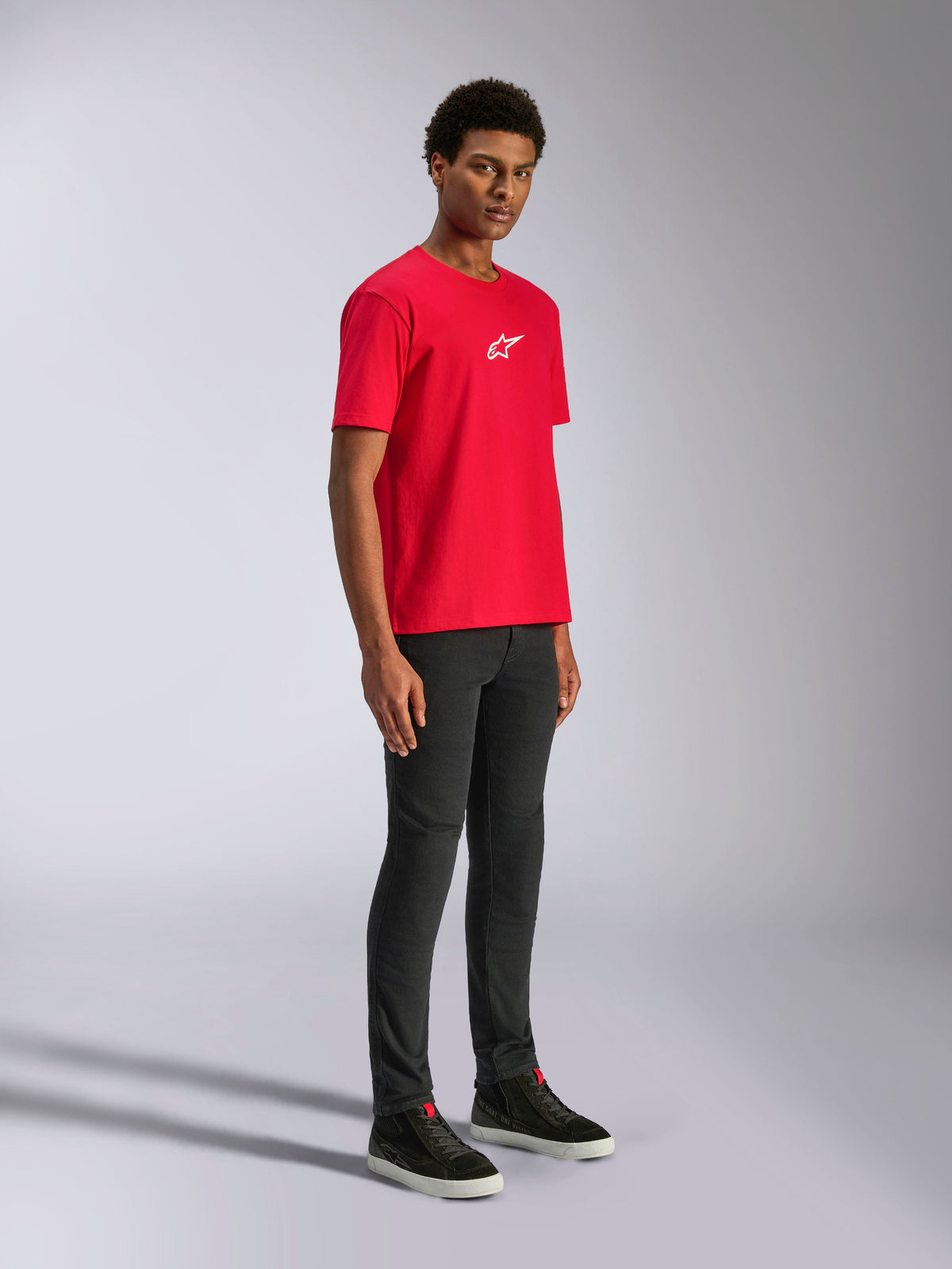 Alpinestars Frontal CSF Tee, Short Sleeve T-Shirt, Red, white star logo on the chest, worn by a model with black pants and black sneakers, casual motorsport performance streetwear