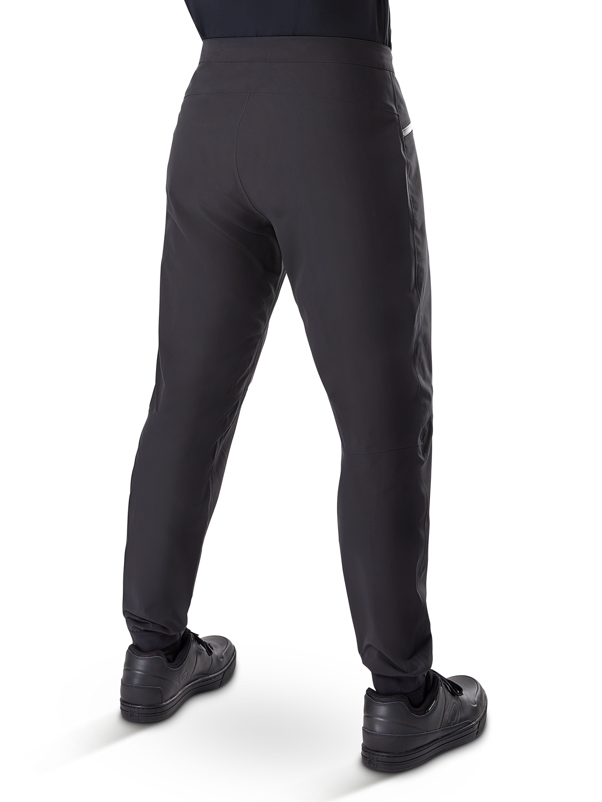 Alpinestars A-Dura Waterproof Pants, Mountain Bike Pants, Black, rear view worn with black shoes, featuring a durable 3-layer membrane, regular fit, and elasticated cuffs for off-road cycling