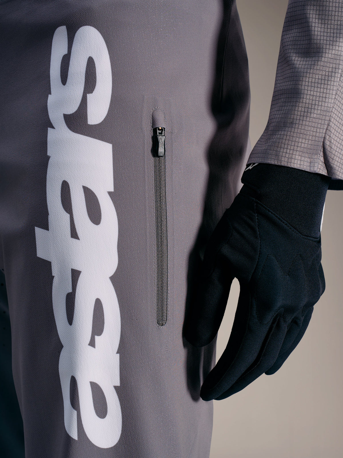 A-Supra Elite Pants in Faded Gray with a bold white logo and vertical zippered pocket, engineered for MTB racing performance.