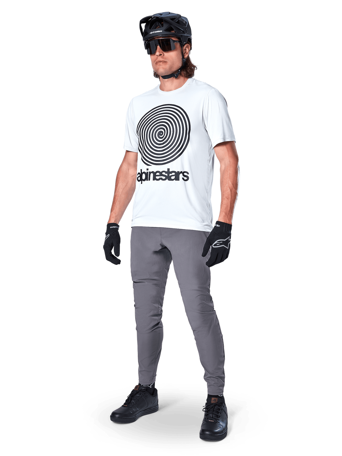 Alpinestars A-Dura Pants, MTB Pants, Dark Gray, worn with white spiral graphic t-shirt, black MTB helmet, sunglasses, and black gloves, durable 2-way stretch textile for off-road cycling