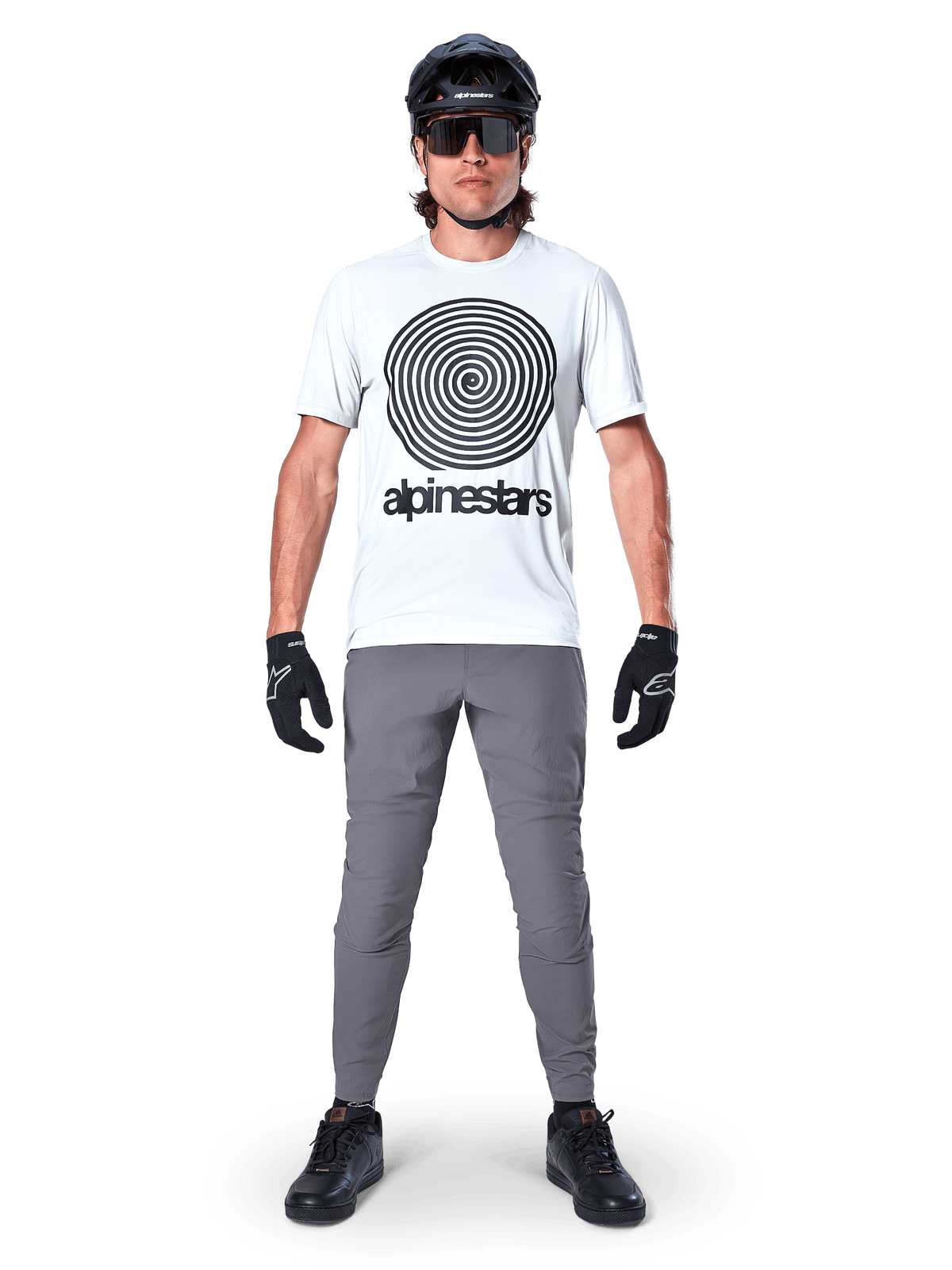 Alpinestars A-Dura Pants, MTB Cycling Pants, Dark Gray, worn with a white graphic t-shirt, black helmet, and gloves, featuring a durable 2-way stretch design and regular fit for mountain biking