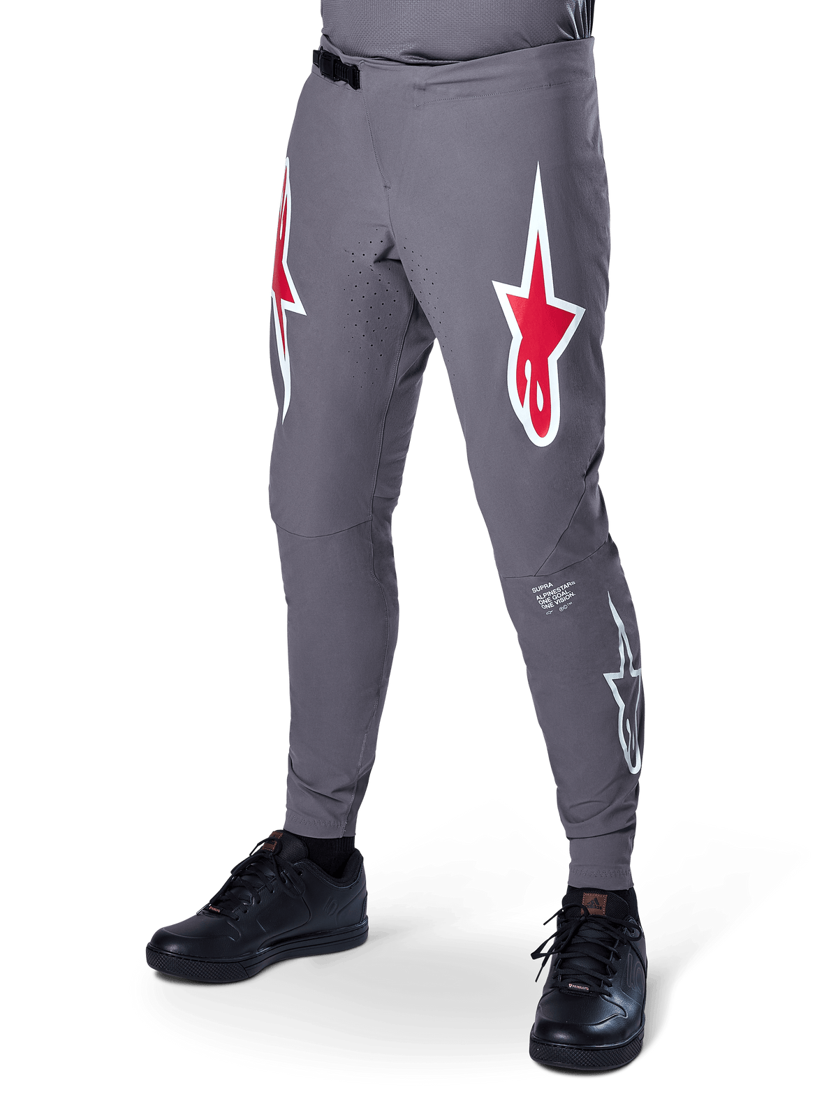 Alpinestars A-Supra Race Pants, Dark Gray Mountain Bike Pants, featuring large red and white star logos on thighs, laser-perforated ventilation, and a ratchet waist closure, performance fit for downhill and enduro racing