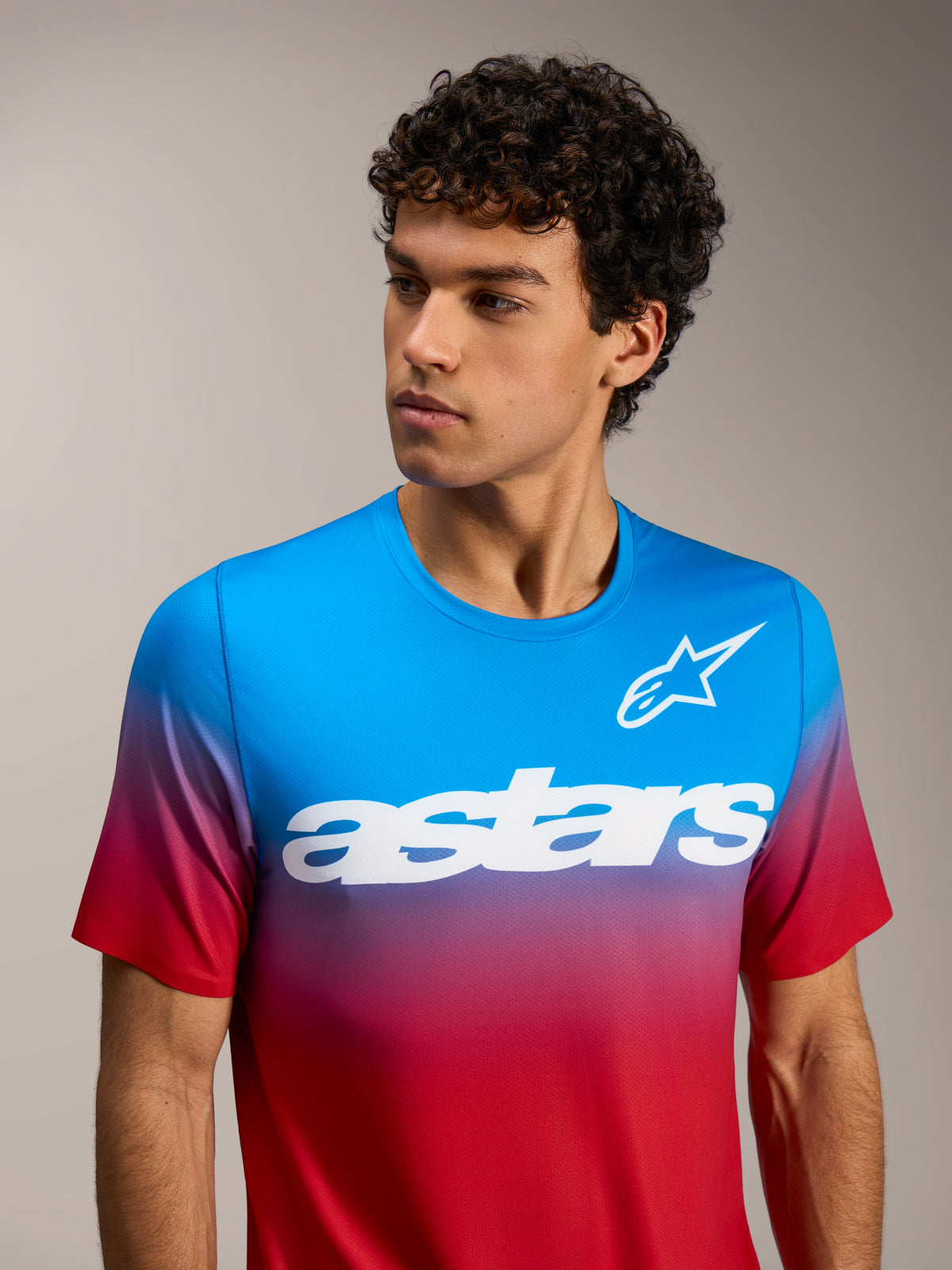 A-Dura ASTARS 2.0 short sleeve jersey in bright red and blue gradient featuring a white chest logo for MTB performance.