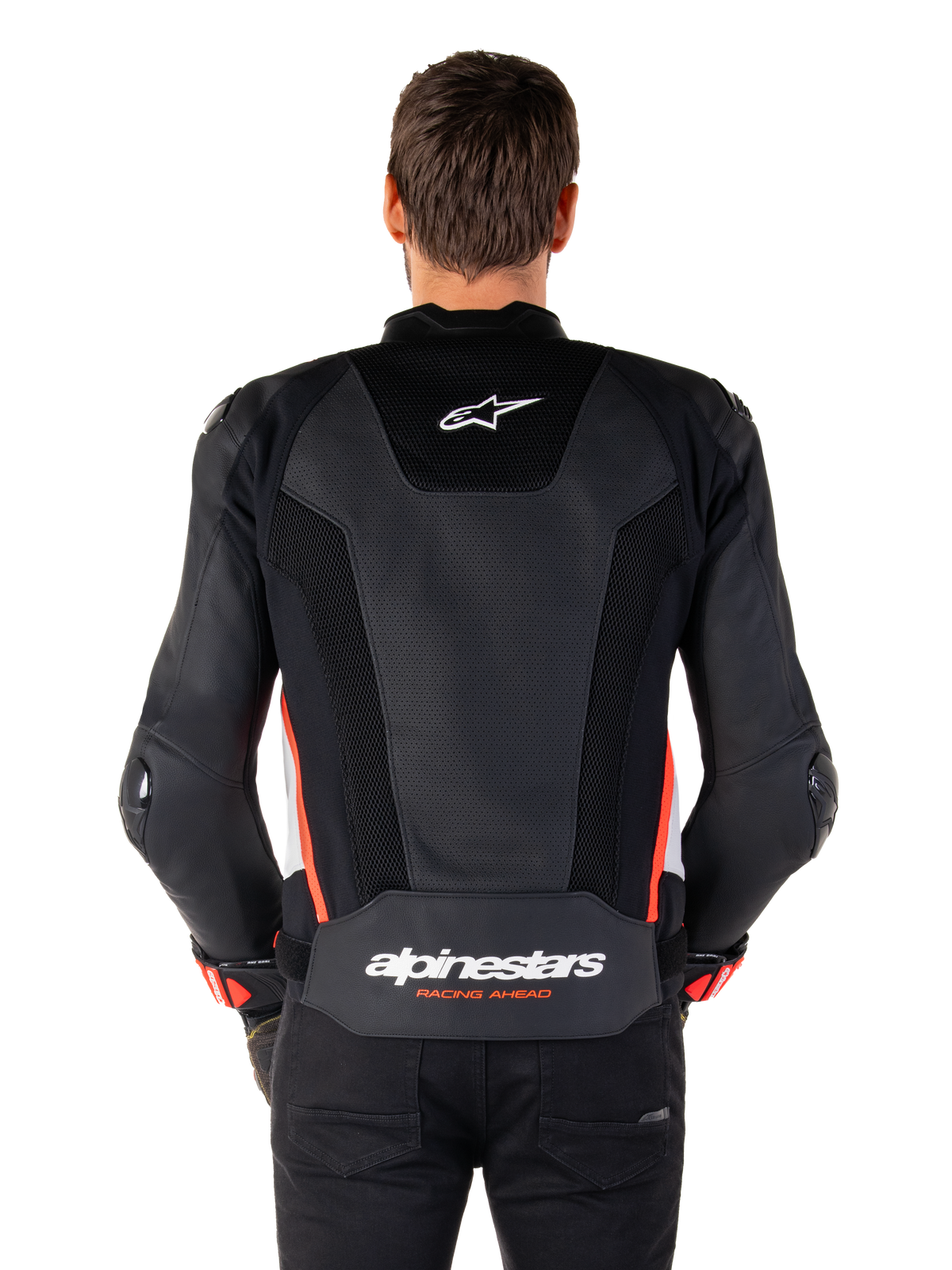 Rear view of a person wearing the Alpinestars Missile V3 Airflow Leather Jacket in Black White Red Fluo, featuring extensive perforated leather panels for ventilation, a small Alpinestars logo on the upper back, and bold 'alpinestars RACING AHEAD' branding on the lower waist.