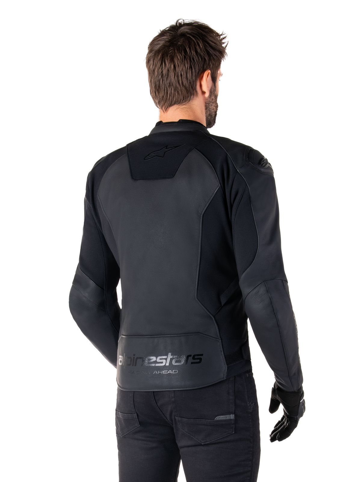 Alpinestars Faster V3 Leather Jacket, Black Black, Rear view of model wearing the sport riding jacket, featuring 'alpinestars' and 'RACING AHEAD' branding on the lower back, premium leather with matte panels, modern sport silhouette for motorcycle riding