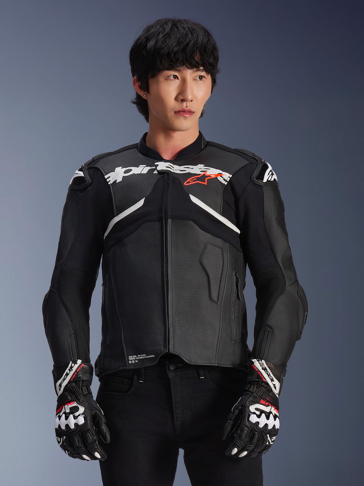 Alpinestars Atem V5 Leather Jacket, Motorcycle Racing Jacket, Black with White and Red Accents, premium leather construction with armored protection, worn with matching racing gloves