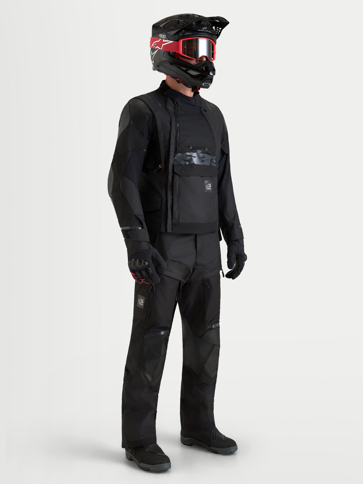 Alpinestars Harok V2 Drystar Jacket, men's all-terrain adventure motorcycle jacket in black, worn with matching black riding pants, helmet, and goggles, featuring CE-certified protection and waterproof construction.