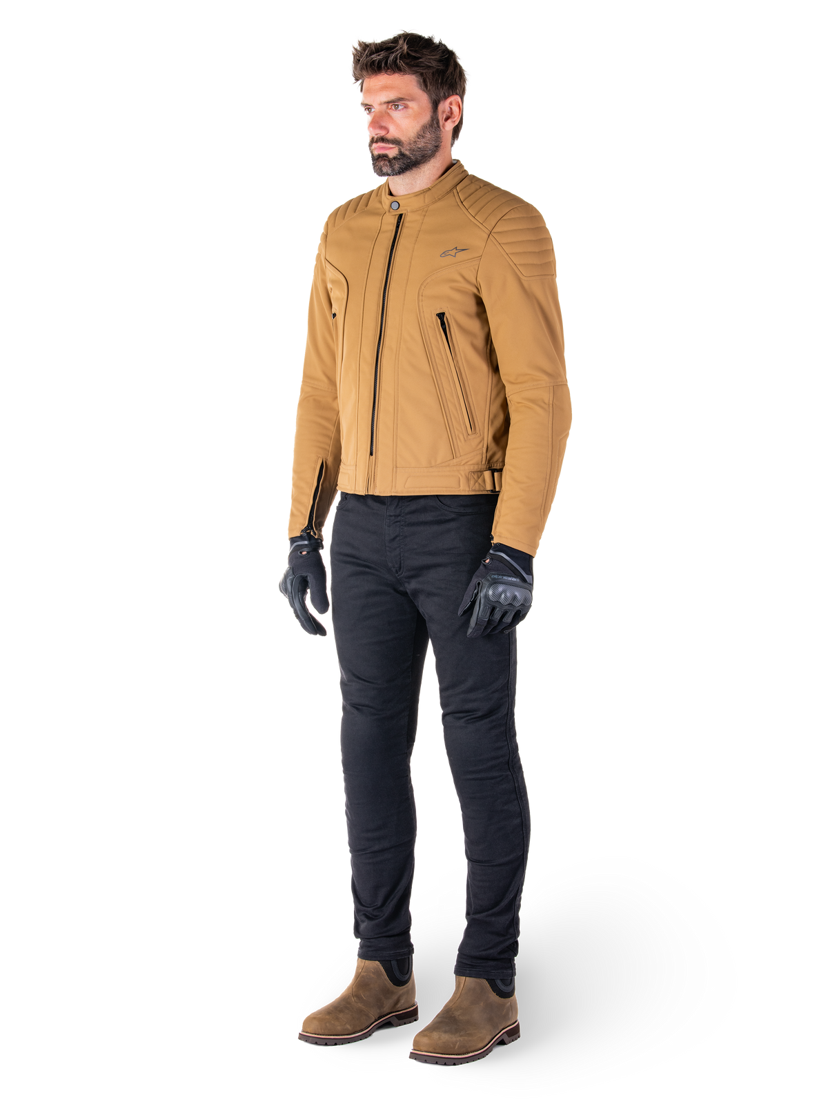 Male rider wearing the Alpinestars Clayton WR Jacket in Utility Brown Light Gold, urban contemporary motorcycle jacket with quilted shoulder details, styled with black pants, black gloves, and brown boots