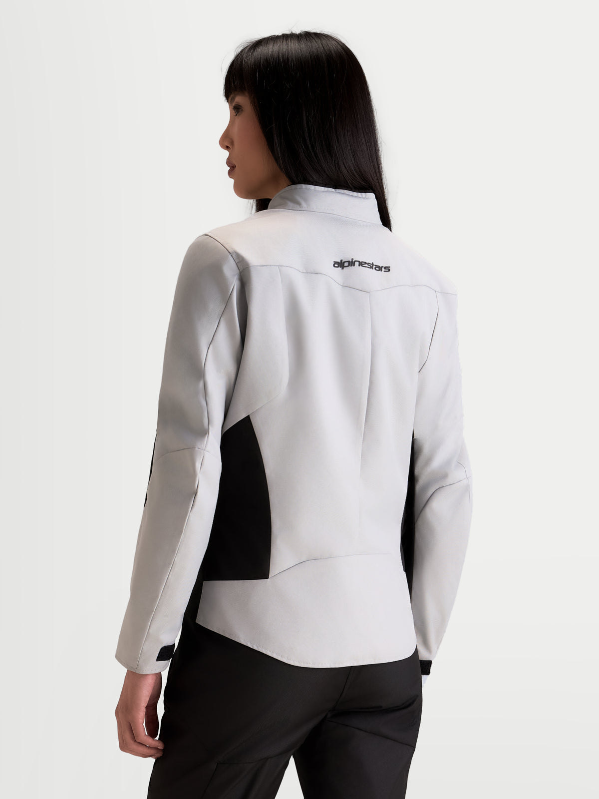 Alpinestars Stella C-1 Waterproof Jacket, women's urban motorcycle jacket in ice gray and black, rear view on a model showing 3D back construction and brand logo on the upper back.