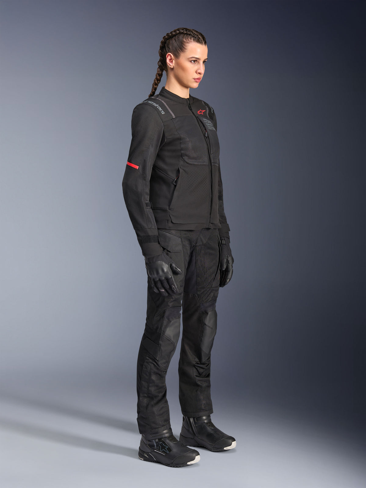 Female rider wearing Alpinestars Stella Andes Air Drystar® Pants in Black, textile adventure pants with mesh ventilation panels, styled with a matching Stella jacket, gloves, and boots for a complete motorcycle touring outfit.
