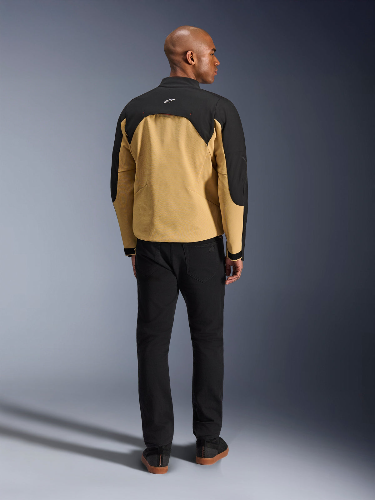 Alpinestars Provoke Jacket, Black and Camel, rear view of urban motorcycle jacket featuring a black upper yoke and camel lower back, worn by model with black pants, contemporary streetwear-inspired design