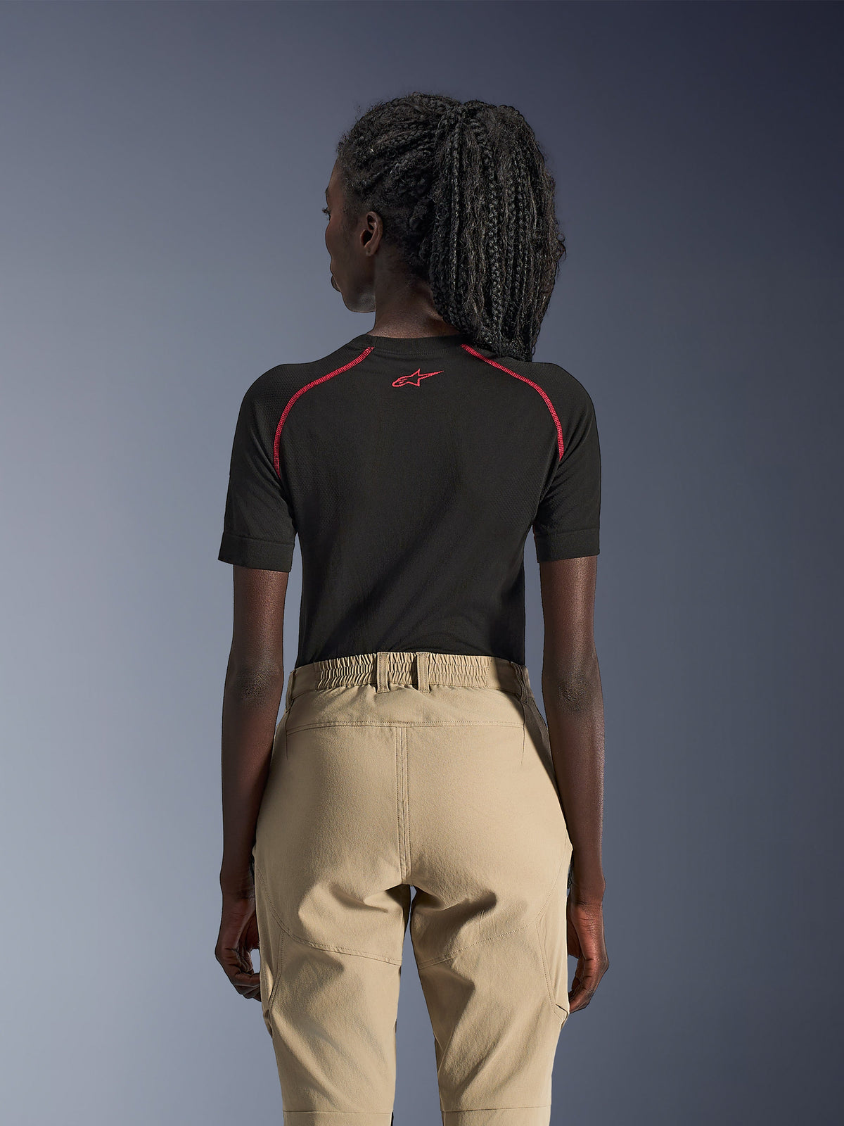 Alpinestars Woman Stella Flex-AST Explorer Pants, Sand, Adventure Motorcycle Pants, rear view worn with a black short-sleeve base layer with red accents, features elastic waistband and durable textile construction