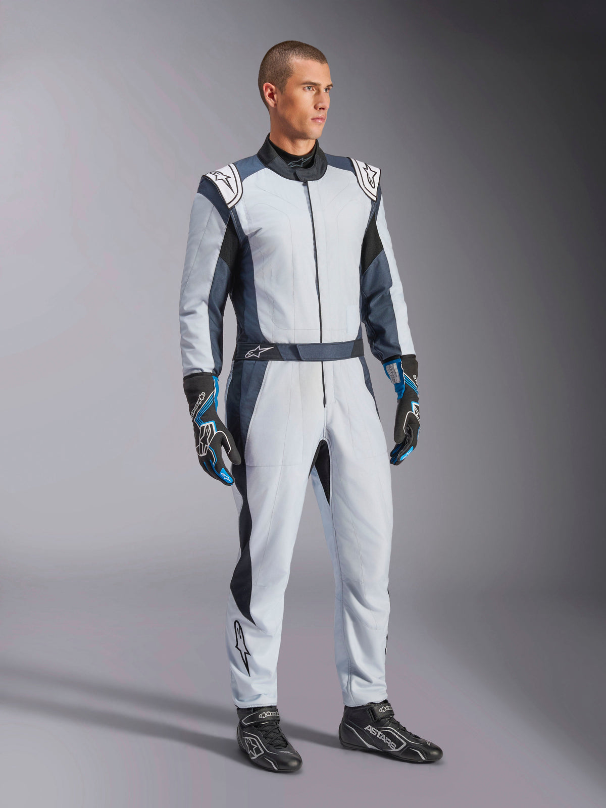 Alpinestars GP Pro Comp V2 FIA Suit, men's gray and black aramid auto racing gear for professional driving.
