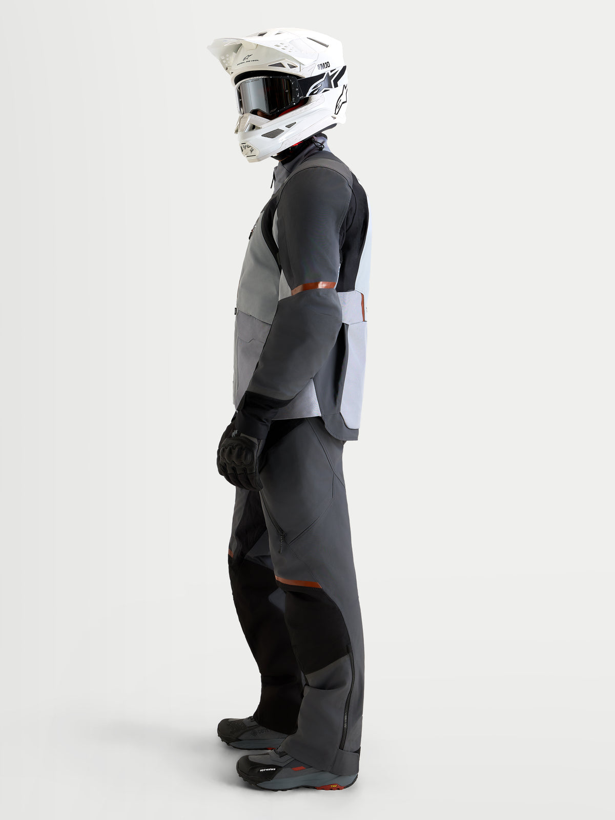 Alpinestars St-7 V2 2L Gore-Tex® Gear Set, adventure touring motorcycle gear set including jacket and pants in mid gray, deep gray, and black, side profile view on a model wearing matching helmet and boots.