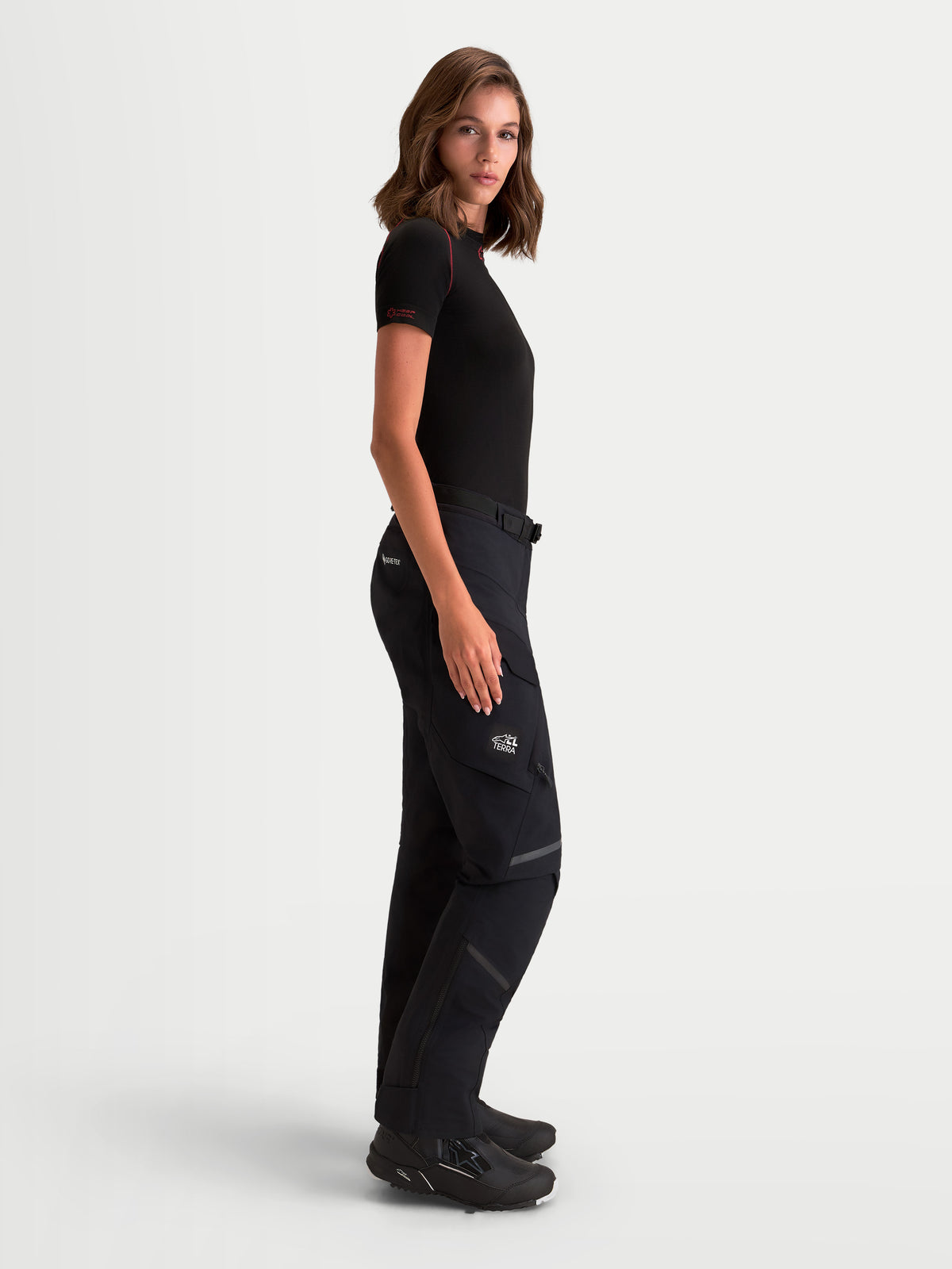 Alpinestars Stella ST-7 V2 2L Gore-Tex Pants Short, women's adventure touring motorcycle pants in black, side profile view worn by a model, featuring waterproof GORE-TEX construction and cargo pockets