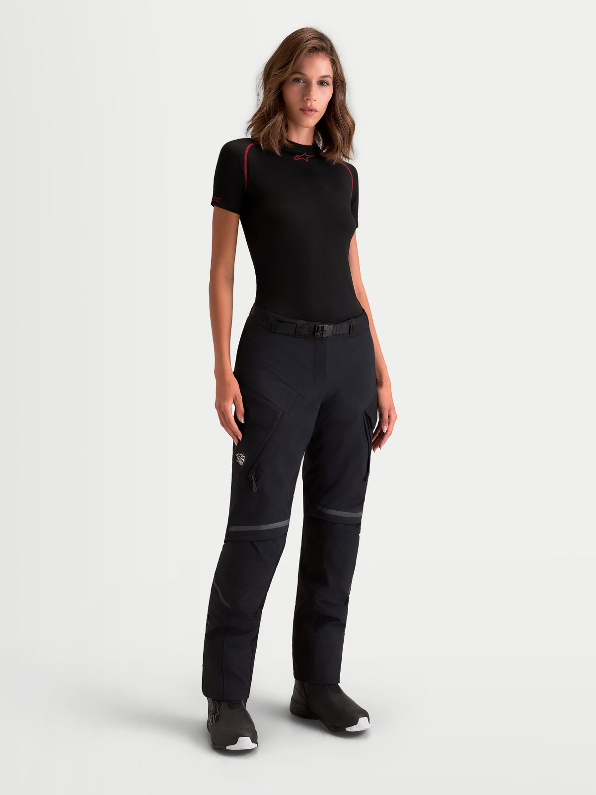 Alpinestars Stella St-7 V2 2L Gore-Tex Pants, women's adventure touring motorcycle pants in black, front view worn by a model showcasing waterproof textile construction and cargo pockets.