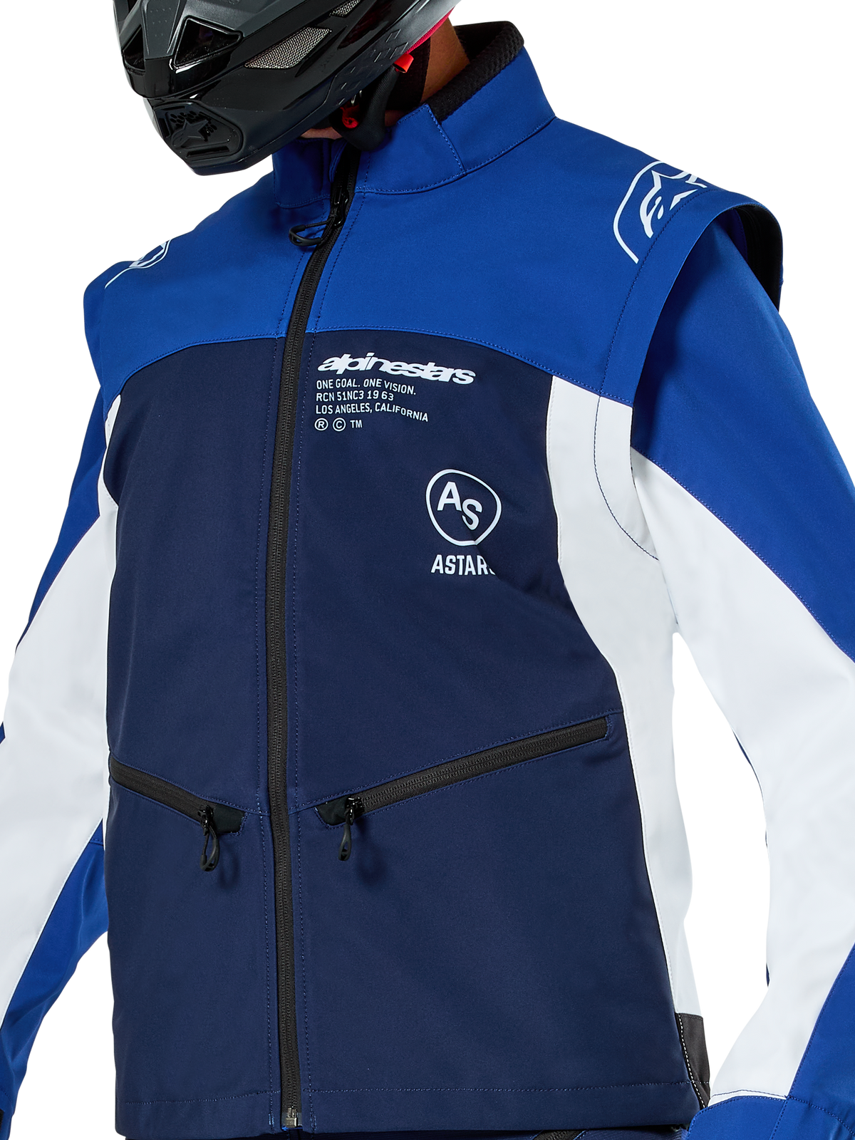 Alpinestars Lite-Dura Softshell Jacket, Motocross and Enduro Jacket, Navy Bright Blue and White, featuring white Alpinestars branding on the chest and zippered pockets, worn with a black helmet, durable softshell construction with detachable sleeves for off-road riding.