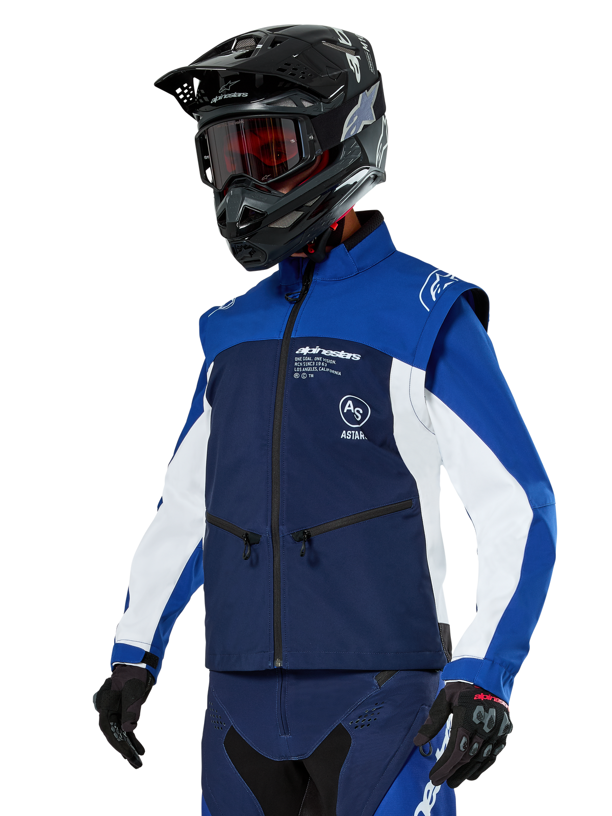 Alpinestars Lite-Dura Softshell Jacket, Navy, Bright Blue and White, Off-Road Enduro Jacket, worn with black helmet and red-tinted goggles, sporty color-block design with multiple zippers and brand logos, durable textile for motocross and trail riding