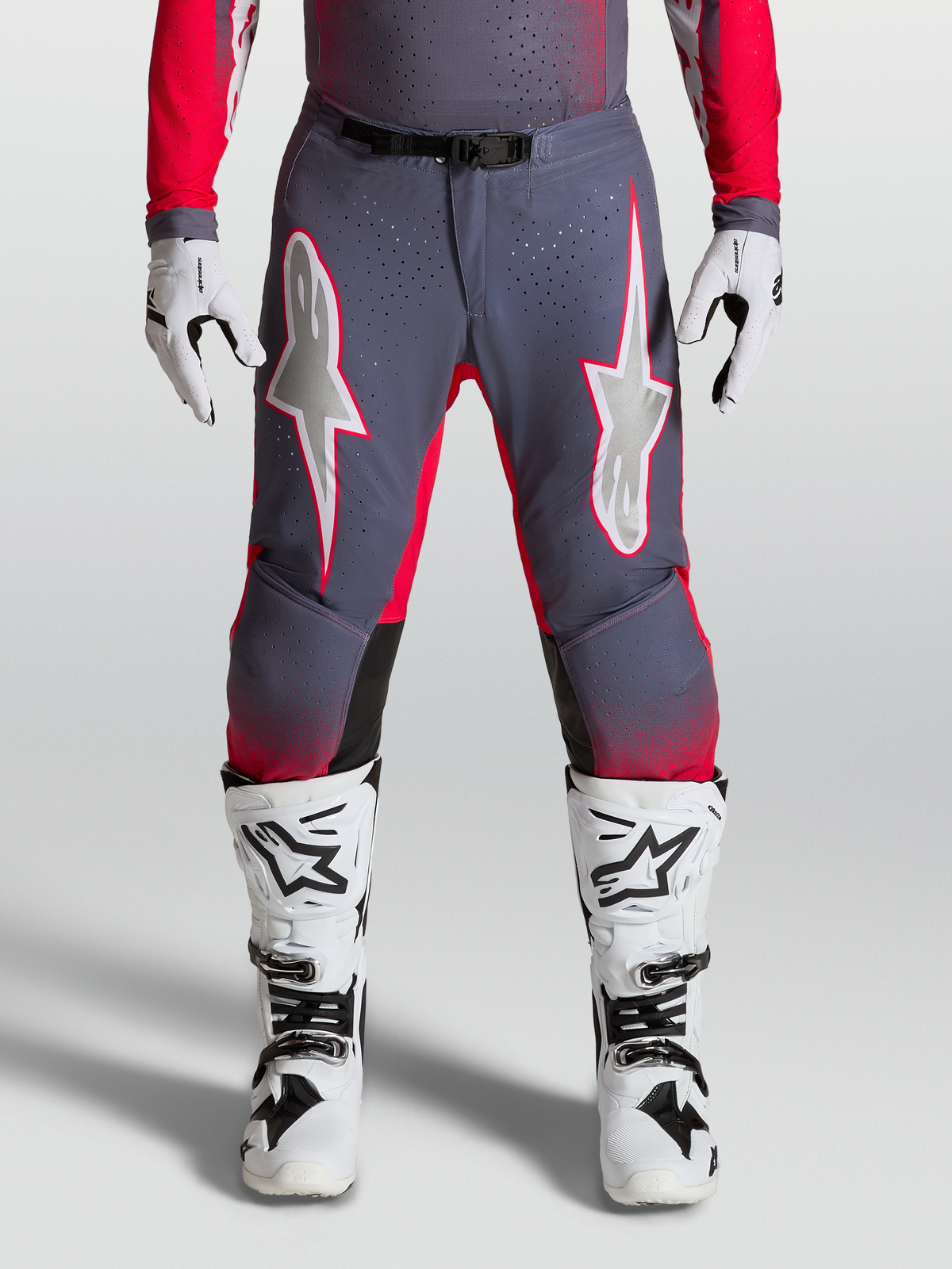 Alpinestars Supertech Hiten AFD Pants, high-performance Motocross gear in Graystone and Red Fluo with light lilac star graphics and perforated stretch panels.