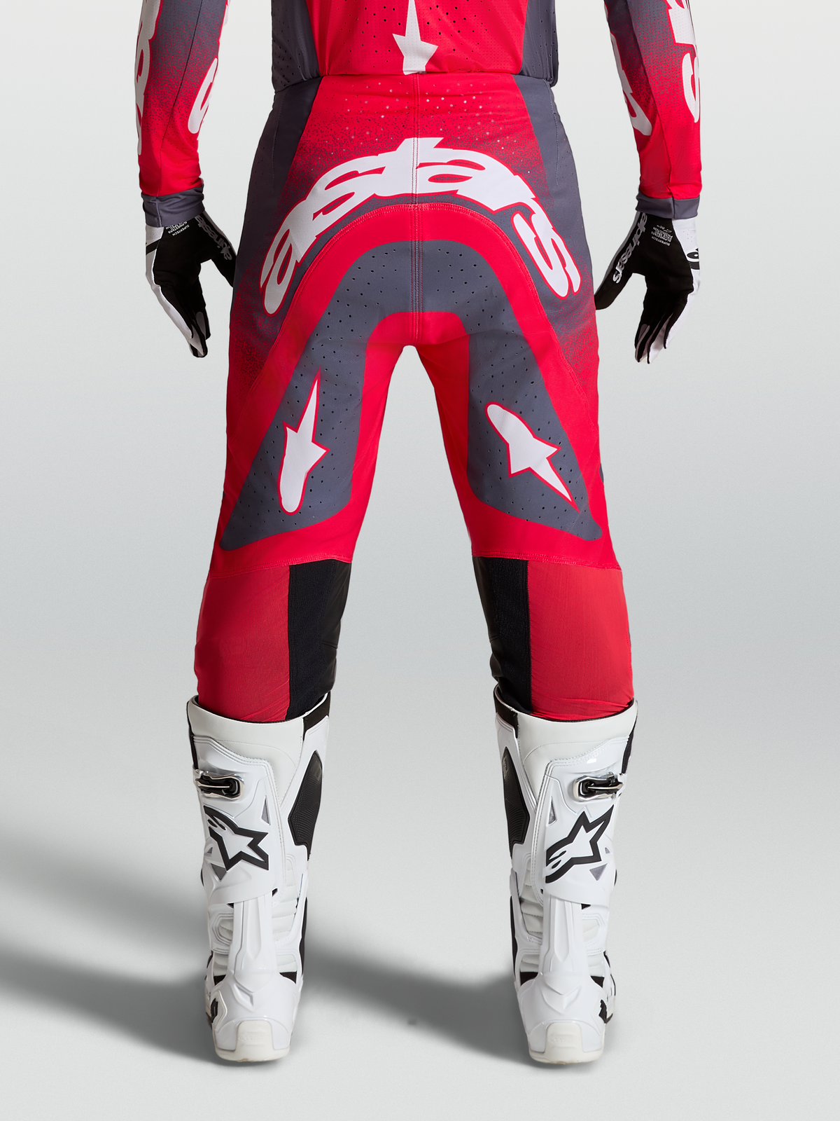 Alpinestars Supertech Hiten AFD Pants, professional motocross racing gear in Red Fluo and Graystone with white logos.