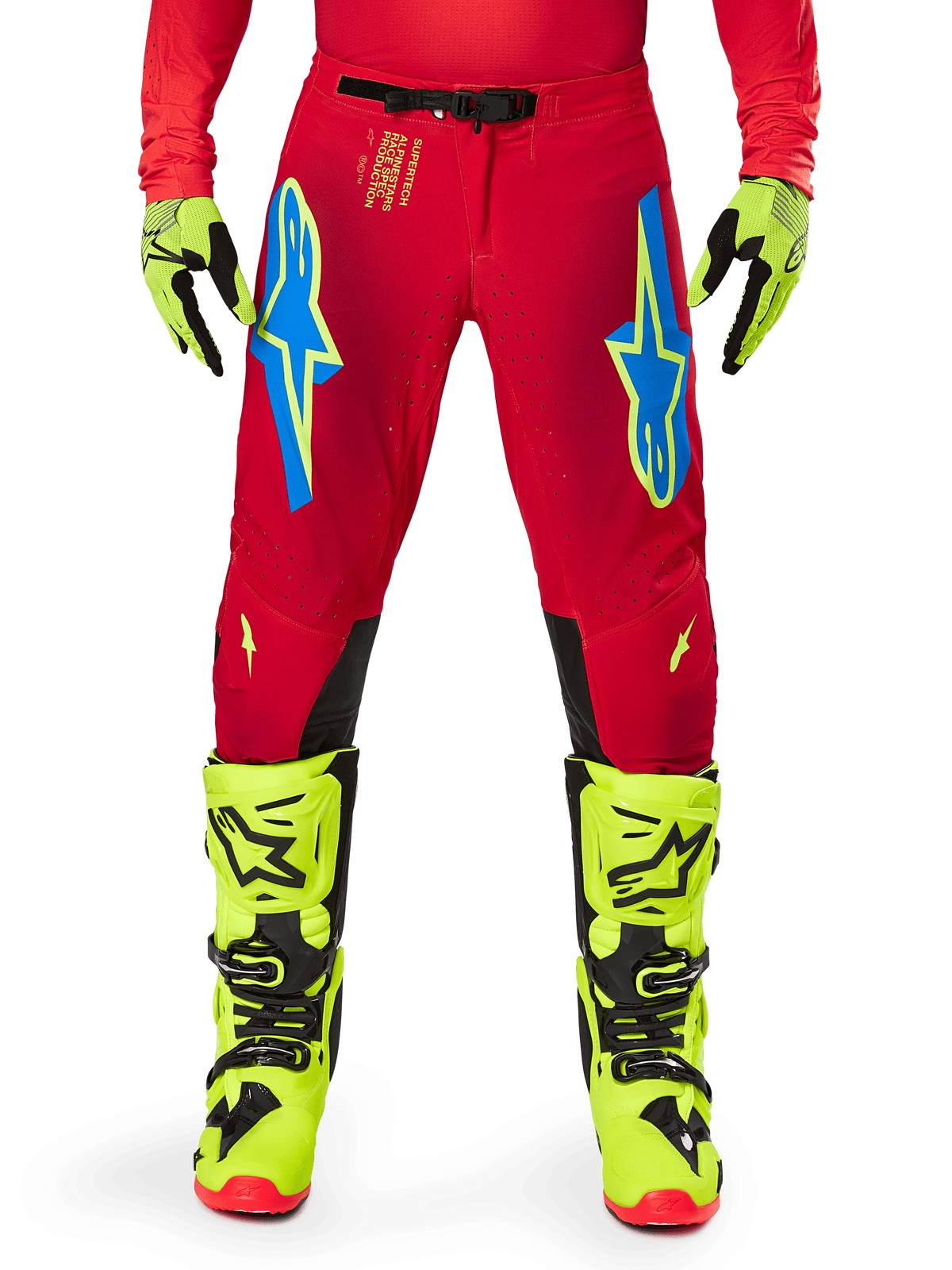 Alpinestars 2025 Supertech Maker Pants, Motocross Pants, Bright Red and Yellow Fluo, featuring blue Astars logos on the thighs, ventilated perforations, and black inner knee panels, worn with matching yellow fluo boots and gloves