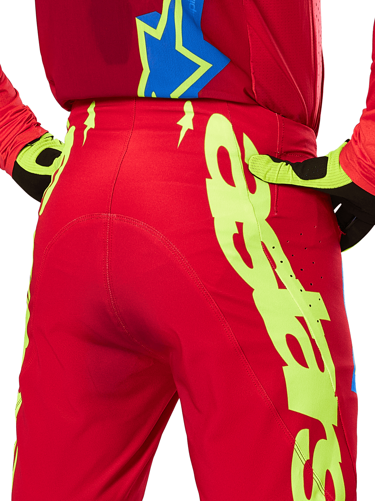Alpinestars 2025 Supertech Maker Pants, Motocross Pants, Bright Red and Yellow Fluo, rear view featuring large yellow graphics on the legs and matching fluo yellow and black gloves, professional off-road racing gear