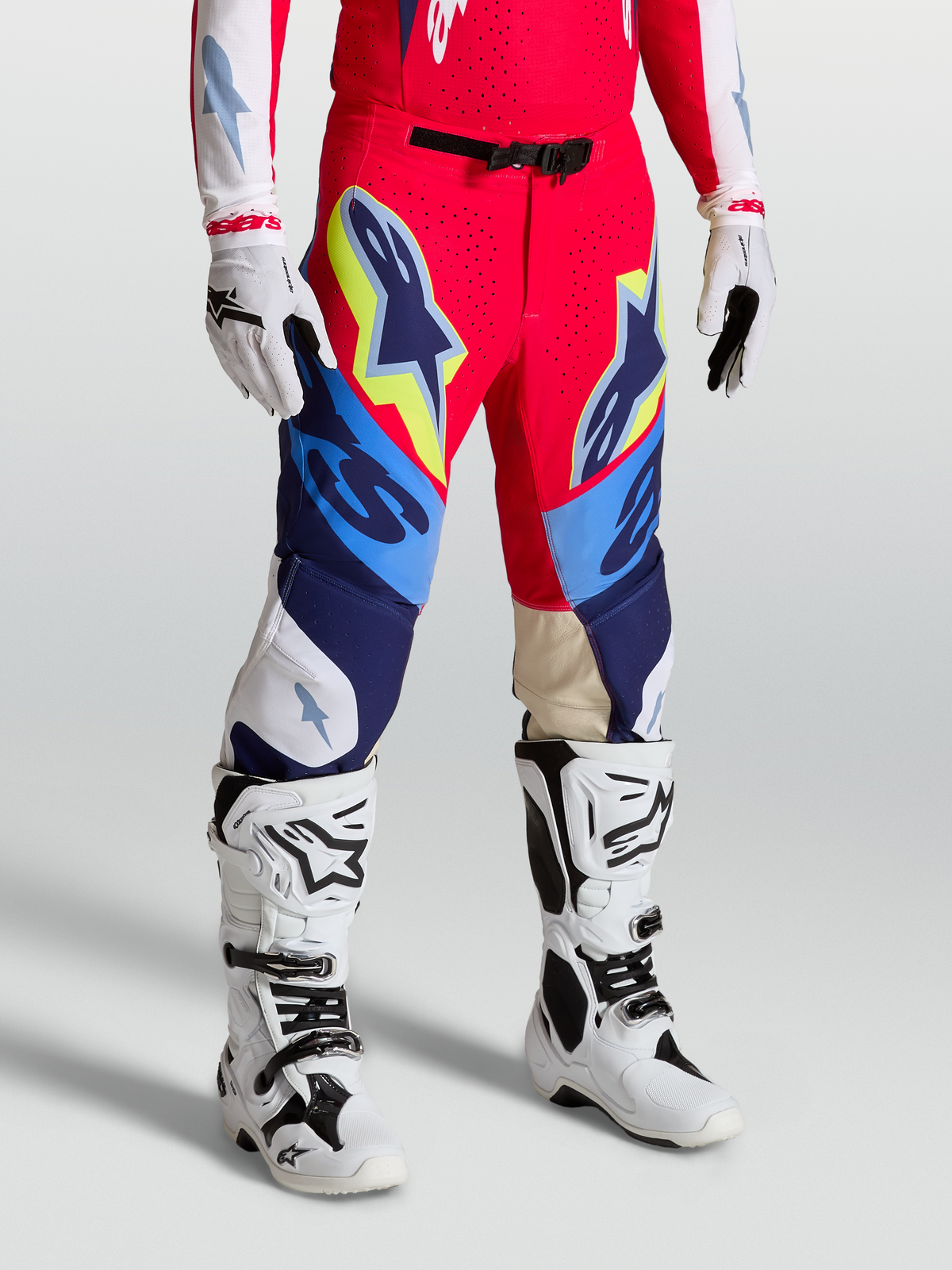 Alpinestars Supertech Dyna Pants, Motocross Racing Gear in Fire Red, White and Navy Blue with athletic fit and stretch panels.