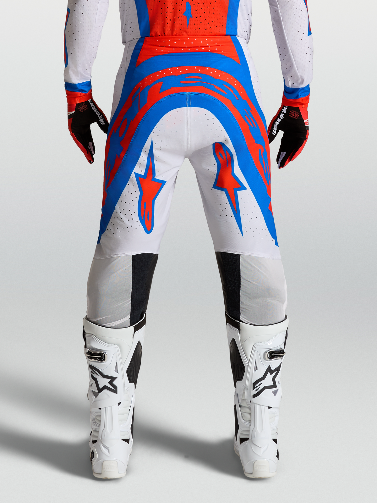 Alpinestars Supertech Vesta Pants, pro-level motocross racing pants in light lilac and cardinal red, featuring an athletic fit and ventilated stretch rip-stop fabric for off-road performance.