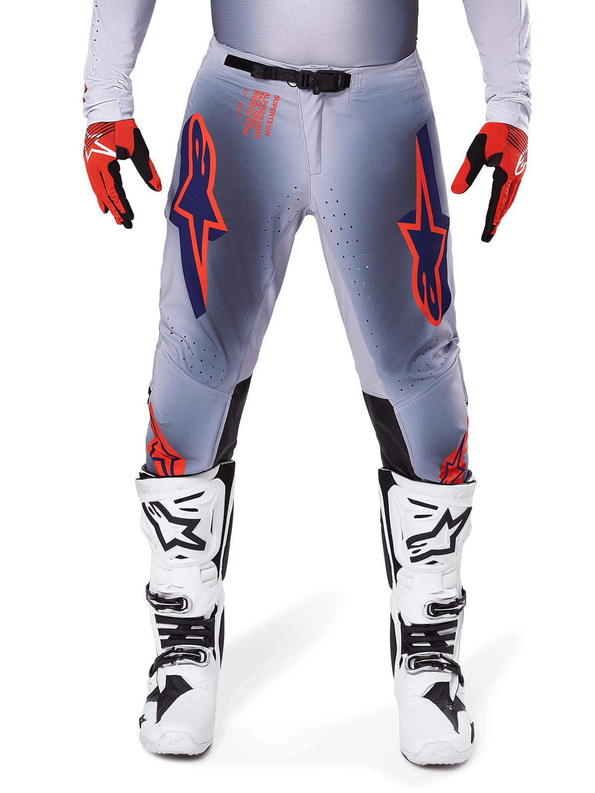 Alpinestars 2025 Supertech Lipan Pants, Motocross Pants, Gray and Orange Fluo, worn with red and black gloves and white and black boots, featuring large Alpinestars star logos on the thighs and ventilation perforations for pro-level racing.