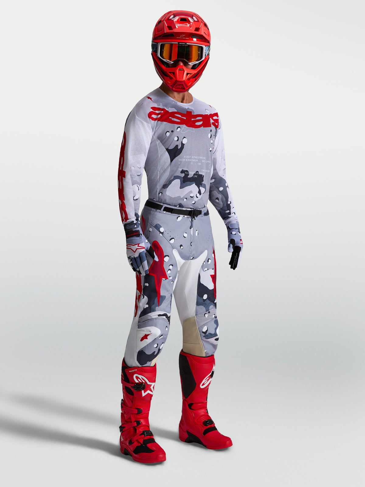 Alpinestars Racer Air Lone Pants and gear set, men's gray camo and red motocross outfit with matching jersey and red boots.