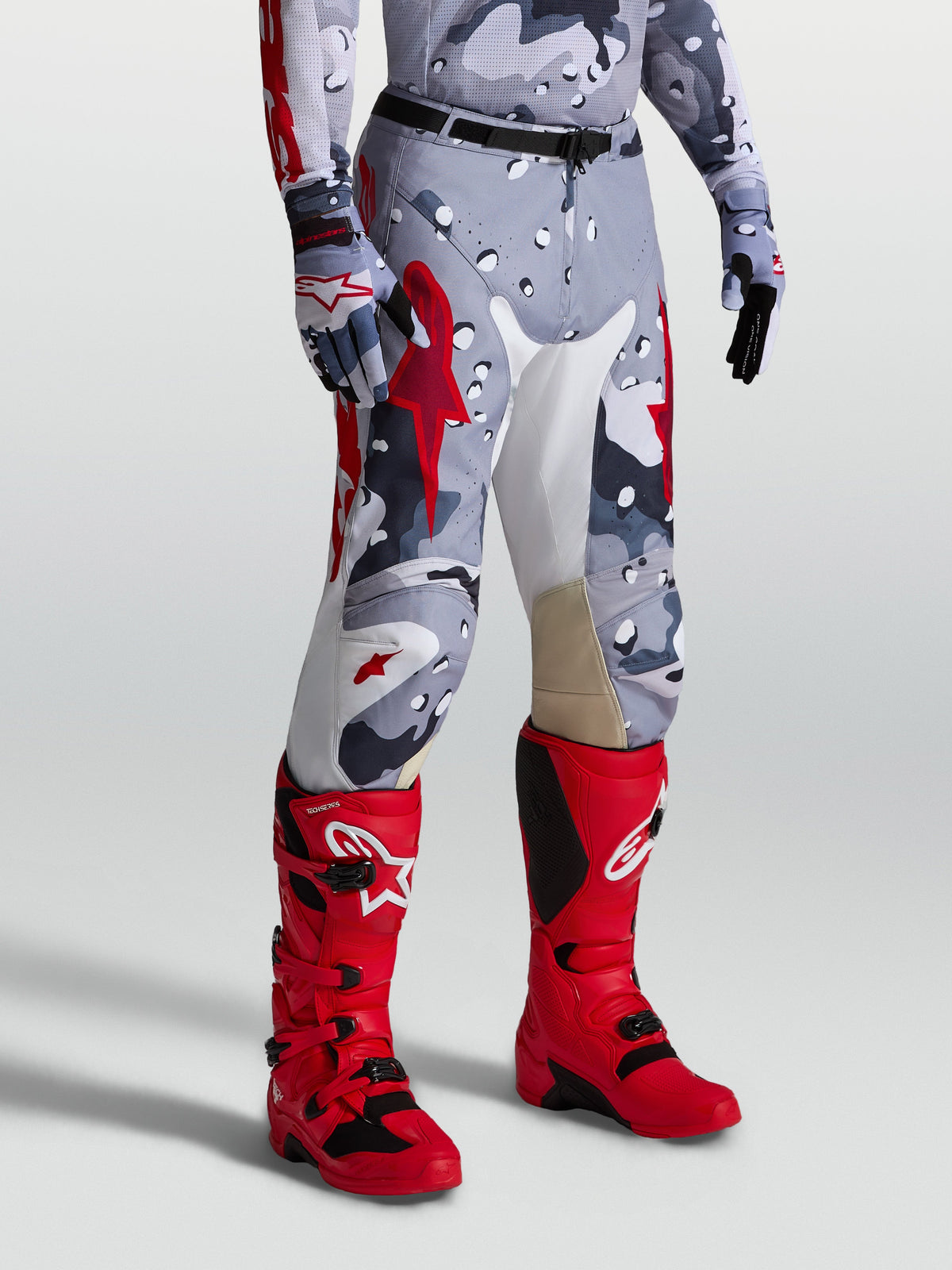 Alpinestars Racer Air Lone Motocross Pants, Gray Camo and Red perforated design for off-road riding, shown on-model.