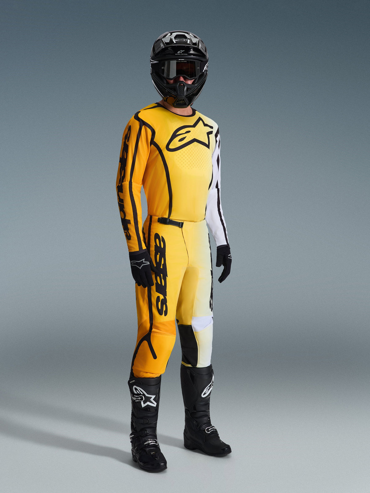 Alpinestars 2026 Fluid Apex Pants, Motocross Pants, Yellow and Black, worn with matching yellow and white jersey, black helmet, goggles, gloves, and black boots, featuring bold black branding and a modern gradient design for off-road racing.