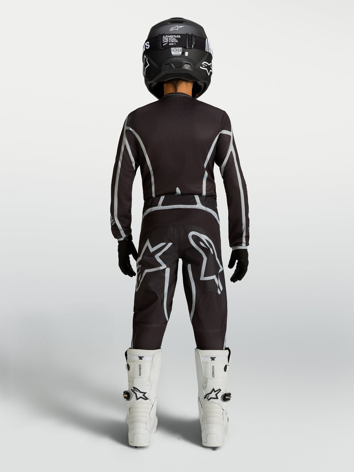 Alpinestars Youth Fluid Apex V2 Pants, black and silver youth MX pants with ergonomic riding fit, shown from the rear.