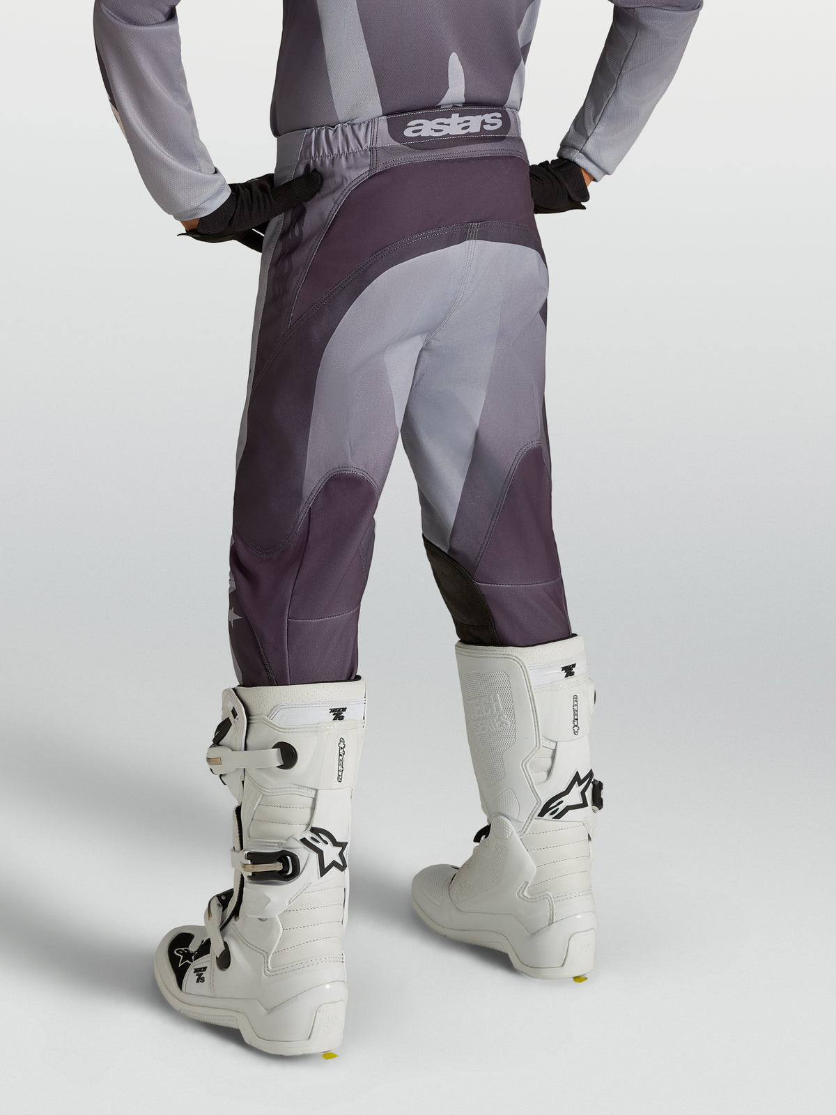 Alpinestars Youth Fluid Amber Pants, youth motocross pants in gray and purple, durable 600D polyfabric, rear view on model.