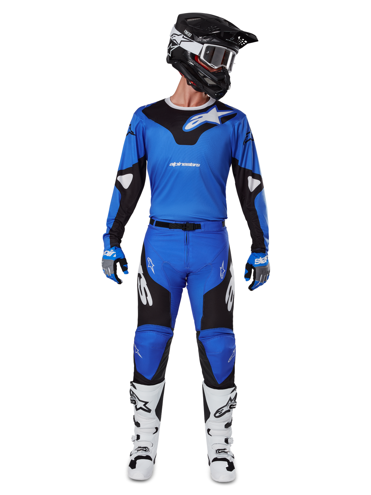 Motocross rider wearing the Alpinestars 2025 Racer Veil Gear Set, blue and black jersey with matching pants, black helmet with white goggles, white and black boots, coordinated racing outfit for off-road motocross.