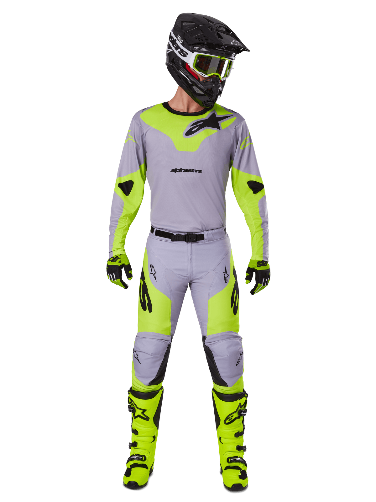 Motocross rider wearing the Alpinestars 2025 Racer Veil Gear Set in Gray and Yellow Fluo, featuring a lightweight jersey and matching pants, paired with a black helmet, fluo goggles, gloves, and high-visibility yellow boots, complete professional off-road outfit