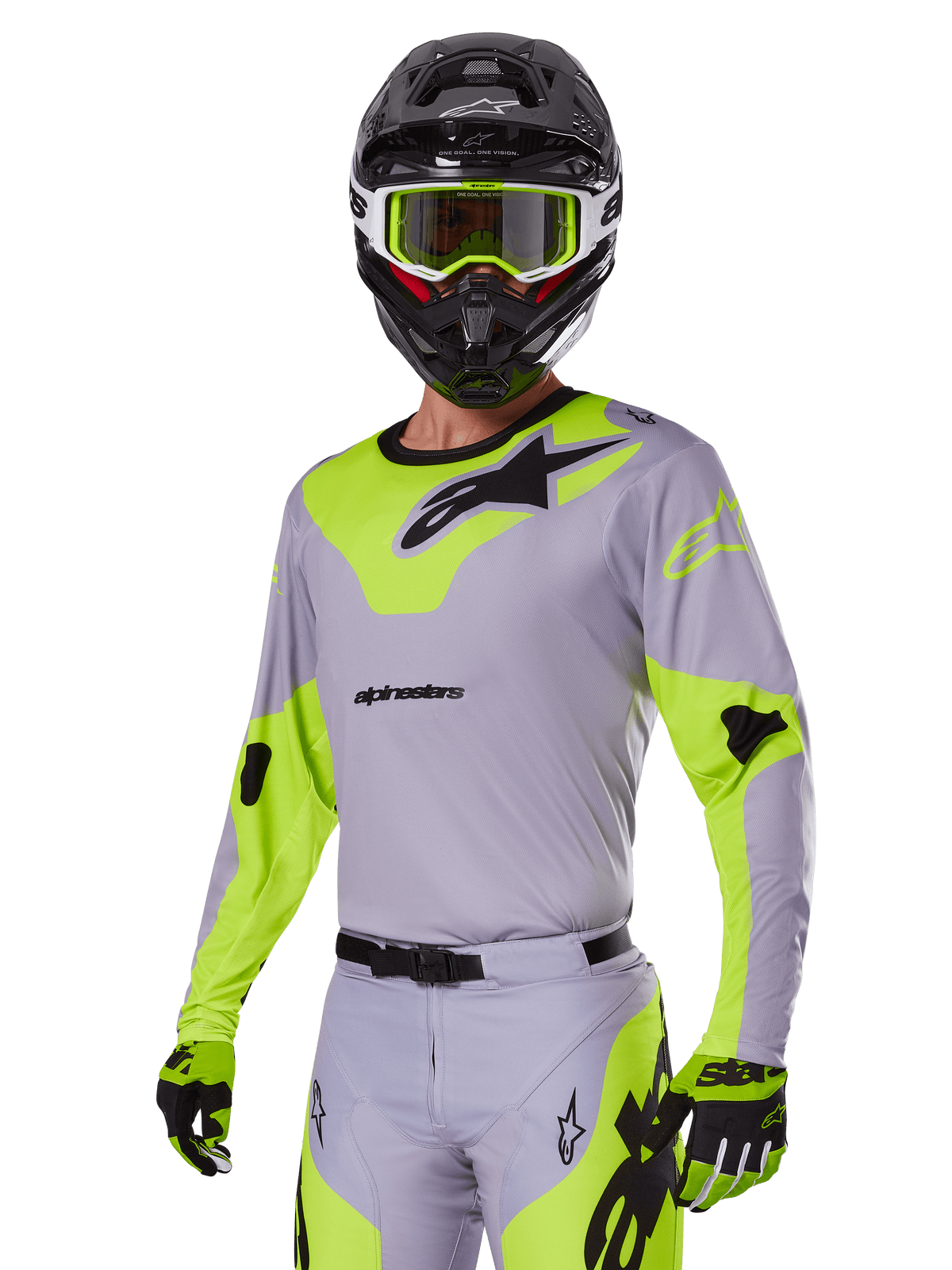 Motocross rider wearing Alpinestars 2025 Racer Veil Gear Set in Gray and fluo green, light gray jersey and pants with bold neon yellow-green panels and black Alpinestars logos, coordinated with matching gloves and a black helmet with neon green goggles, professional off-road racing apparel.