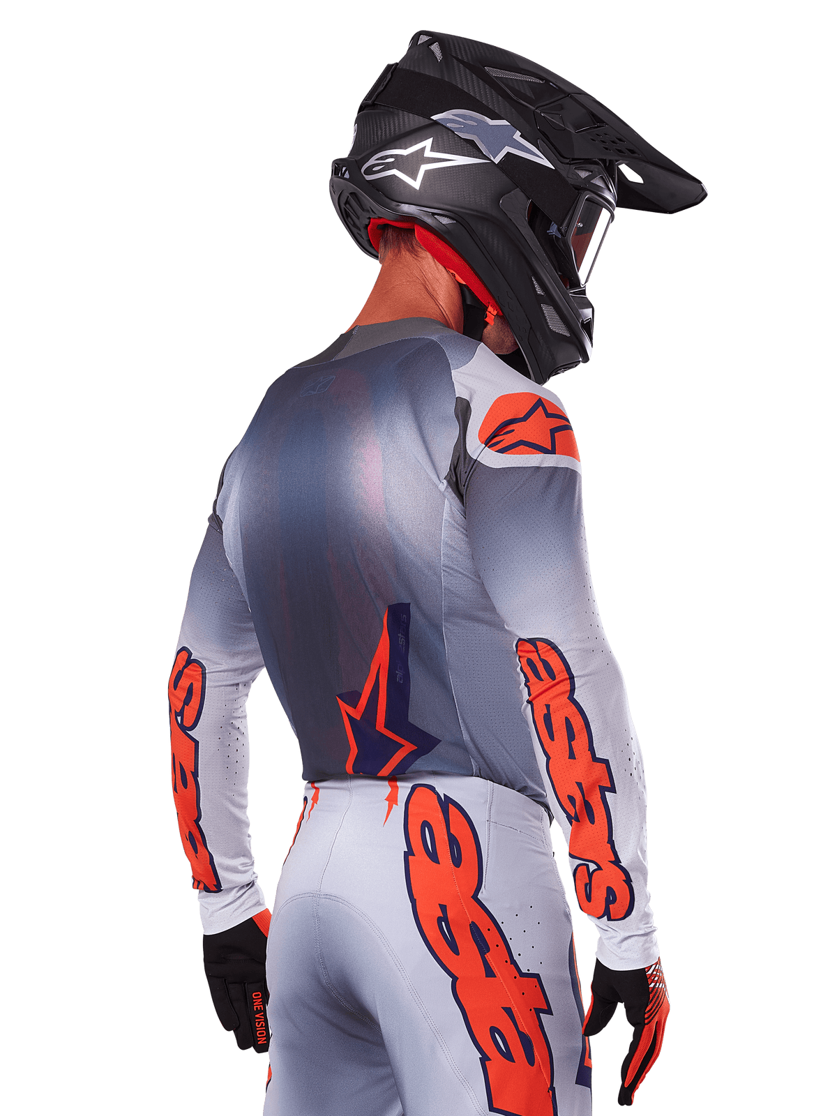 Motocross rider from the back wearing Alpinestars 2025 Supertech Lipan Jersey and Gear Set, Gray with Orange Fluo accents, featuring bold branding on back and sleeves, black helmet, and black gloves, coordinated motocross racing outfit