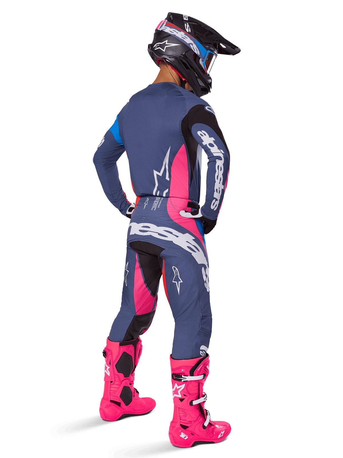 Motocross rider from a rear view, wearing the Alpinestars 2025 Techstar Dreem gear set, Gray with vibrant pink and white accents, black and white helmet, and bright pink boots, complete racing outfit for motocross performance.