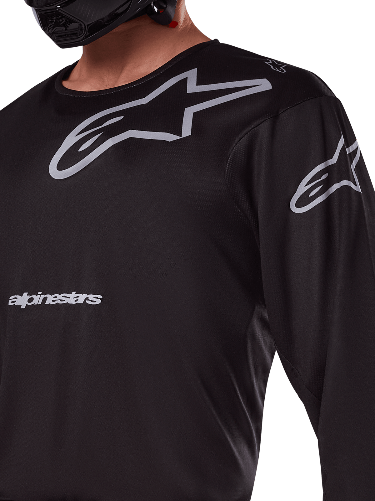 Alpinestars 2025 Racer Graphite Jersey, Black and Gray, close-up of rider wearing motocross jersey, featuring grey Alpinestars branding and A-star logos, technical poly-fabric material for off-road riding