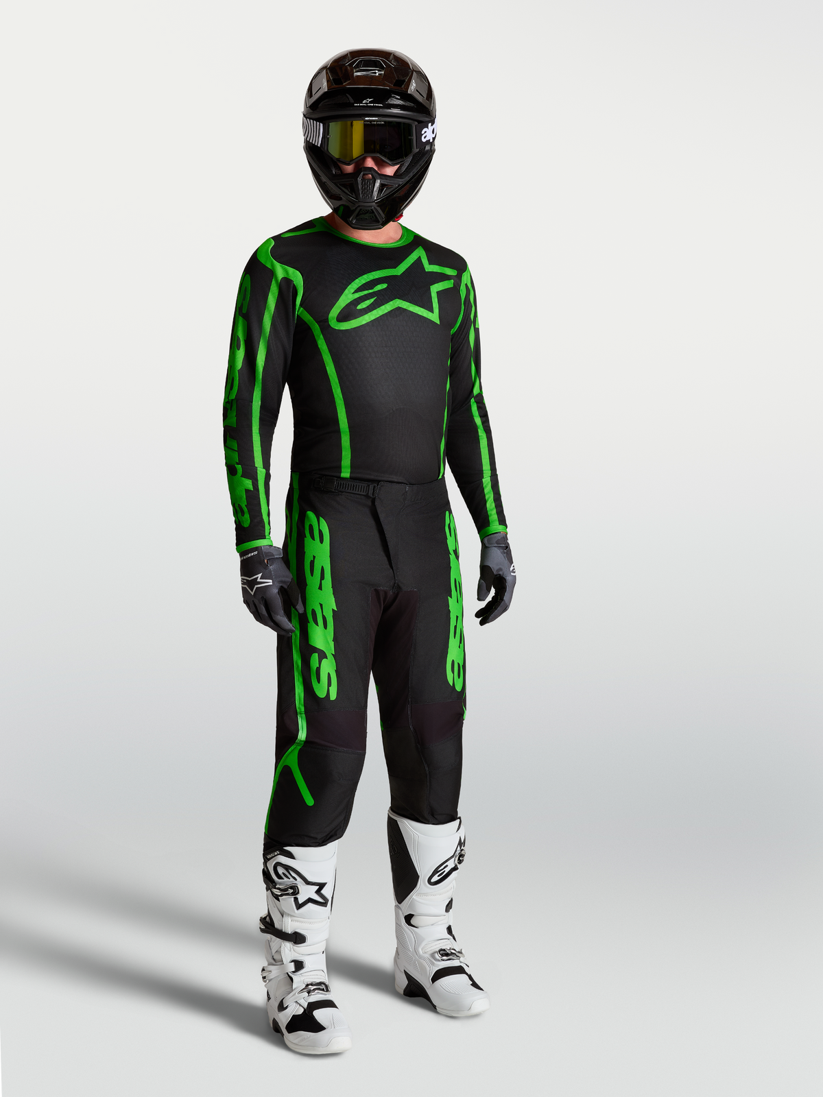 Alpinestars Fluid Apex V2 Jersey, Men's Motocross Gear, Black and Green Fluo, shown on-model with matching pants and boots.