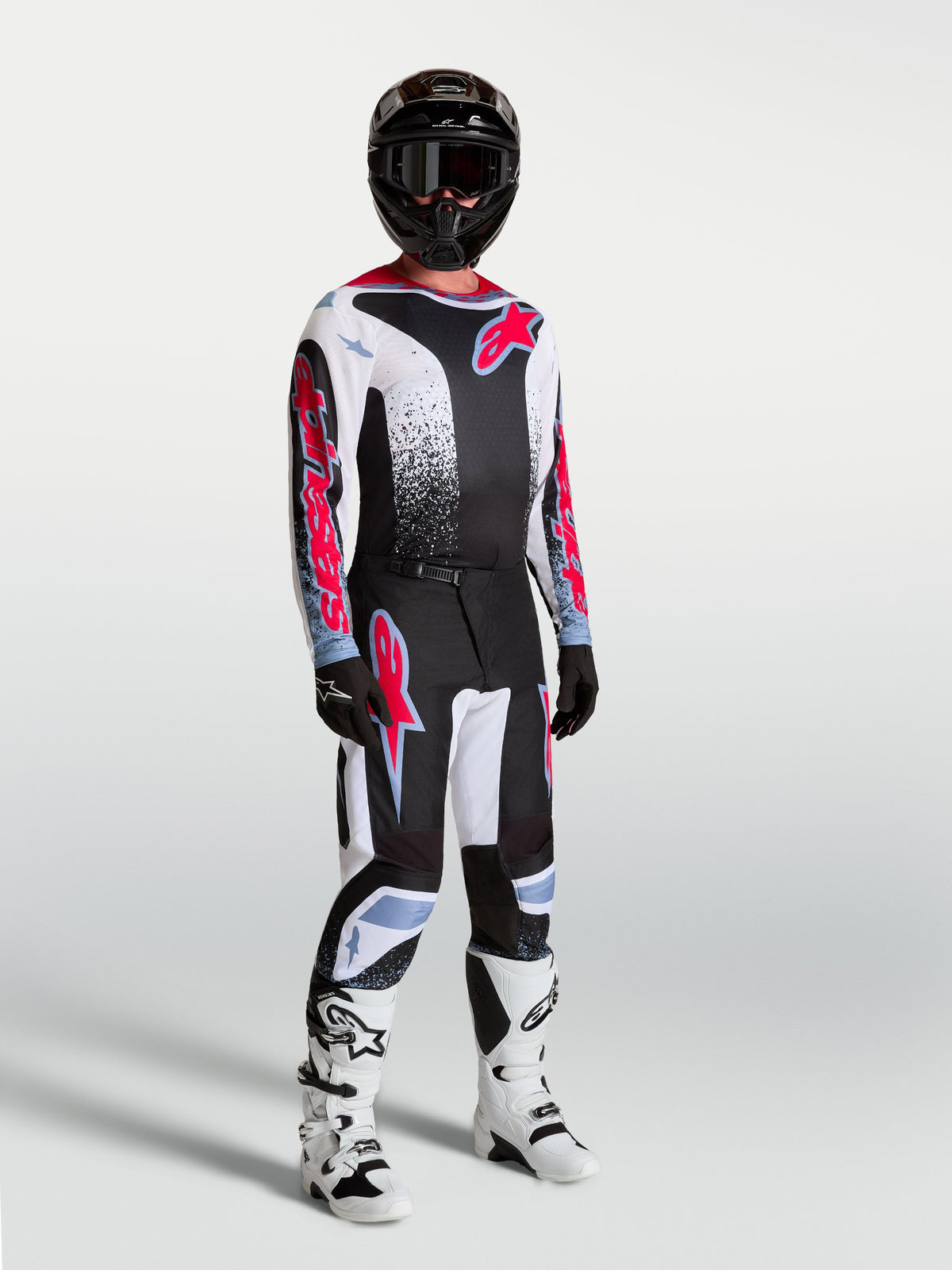 Alpinestars 2027 Fluid Drag Gear Set, men's motocross racing outfit in black and white with red graphics and white boots.